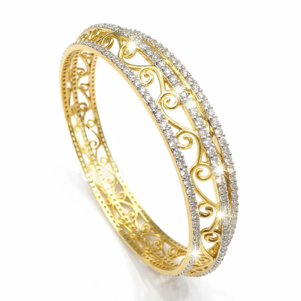 A gold filigree bangle bracelet with two rows of sparkling clear stones, shown on a clean white background.