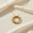 A delicate necklace featuring an ornate floral-inspired pendant. Its graceful detailing and warm gold-tone finish make it a beautiful choice for adding timeless elegance to any outfit.