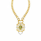 A gold and white gold geometric pendant necklace featuring a central light green gemstone and clear accent stones, displayed on a clean white background.