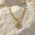 A sophisticated gold-tone necklace with a graceful design and delicate pendant detail. A timeless piece that beautifully complements both casual and formal styling.