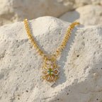A sophisticated gold-tone necklace with a graceful design and delicate pendant detail. A timeless piece that beautifully complements both casual and formal styling.